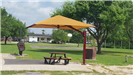Canopy over picnic table with grill in the background