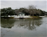 Looking across lake at a small dock and building