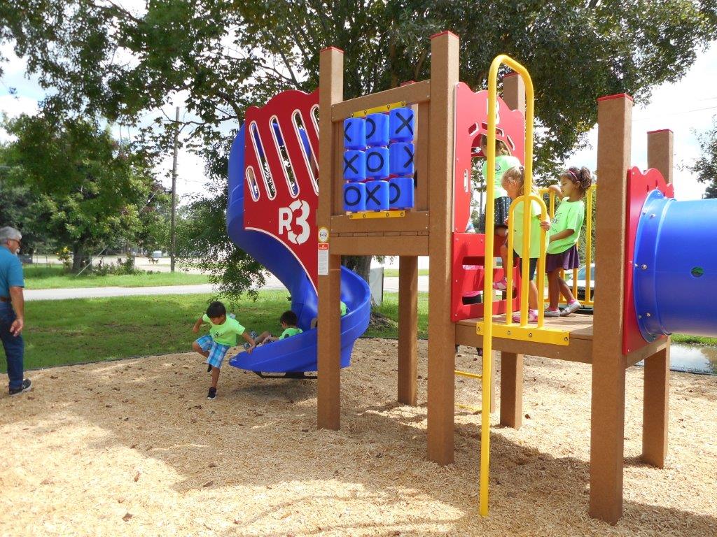 Kids going down the slide at the playground
