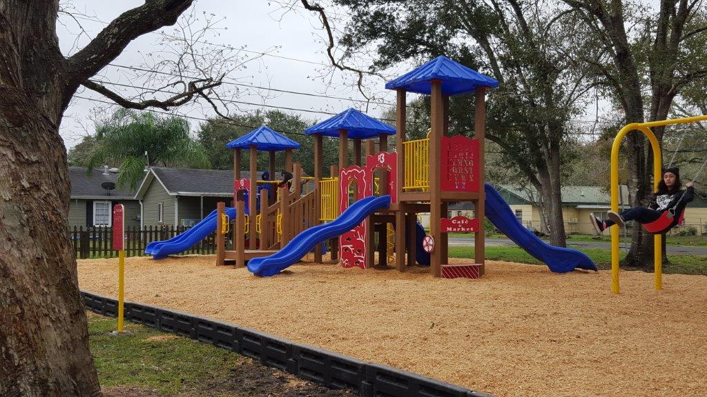 Kid swinging at Highland Park Playground