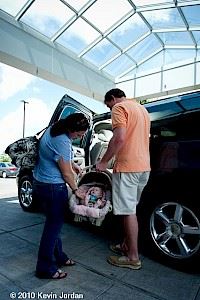 Man and Woman Loading Baby into a Car